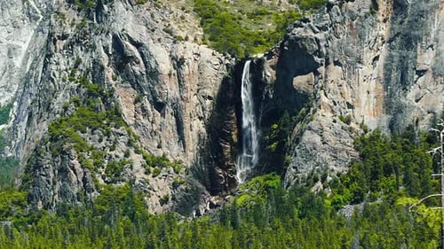 Beautiful slow motion shot of the famous Bridalveil Fall waterfall in Yosemite on a warm sunny summe