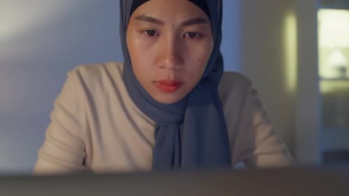 Asia muslim freelancer women face wear hijab casual cloth focus on computer laptop at home office.