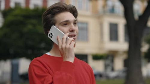 Man Walking Talking on Mobile Phone With Friends on the Street Smiling Guy Making a Phone Call
