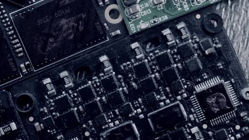 Chips and microcircuits different types in dark colors lie on table rotate, close up.