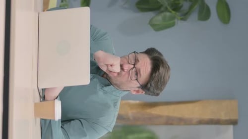 Frustrated Man Using Laptop While Working at Home