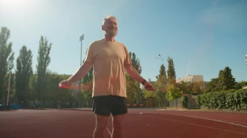 Senior Man Exercising with Jump Rope Outdoors
