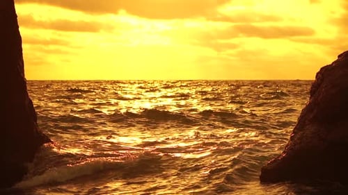 Sea Horizon Line with Waves on Golden Sunset