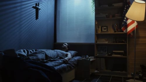 Man Wakes Up and Reminisces in Dark Bedroom