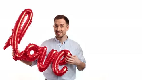 Happy Man Holding Red 'Love' Balloon
