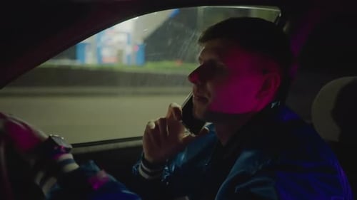 Male Driver in City at Night Nighttime Vehicle Interior with Driver on Call Cinematic Scene of Male