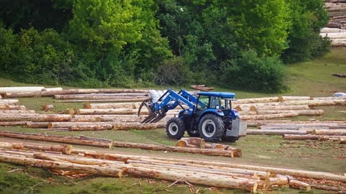 Tractor Moving Logs in a Rural Landscape