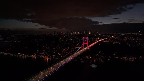 Aerial view of illuminated bridge over river at night, Turkey.
