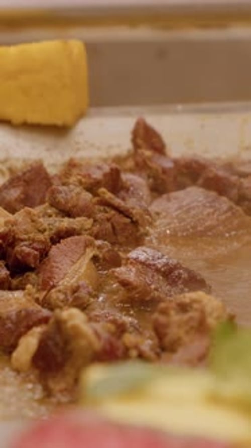 Vertical video Street food vendor cooking meat on hot plate