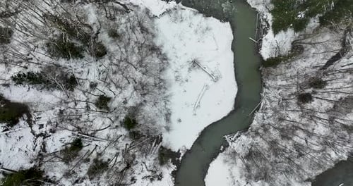 Zoom Out Fly Away Aerial From Icy Frozen River Bend Meander In Above Stillaguamish River