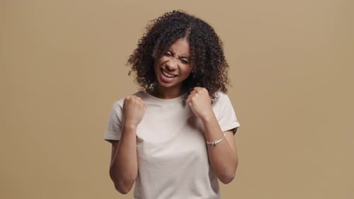 Excited Woman Cheering and Pumping Fists in Celebration