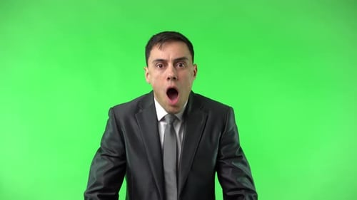 Man in Suit Looks Surprised on Green Screen
