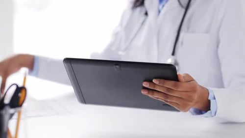 African american female doctor working with tablet computer at hospital