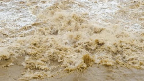 Wide Dirty River with Muddy Water in Flooding Period During Heavy Rains in Spring