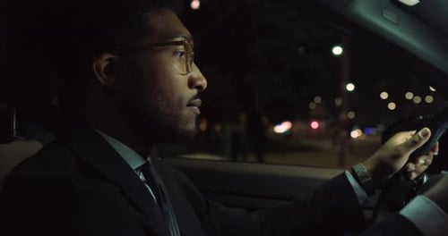 Handsome Black Man Driving a Fancy Car at Night