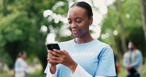 Funny, phone and volunteer woman in park for charity, community outreach or donation update