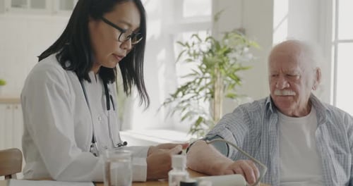 Doctor Checks Blood Pressure of Senior Man