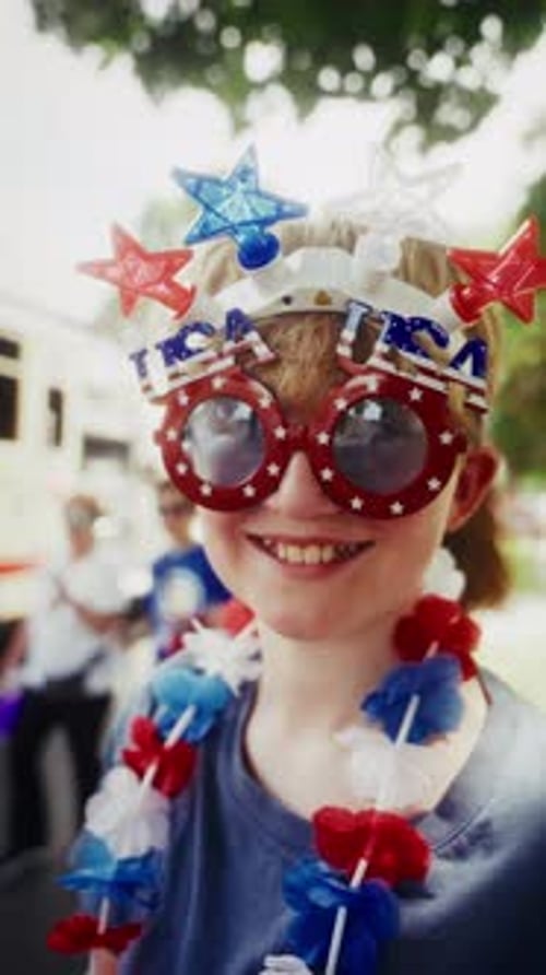 Smiling Boy With USA Glasses And Star Headband On Fourth Of July