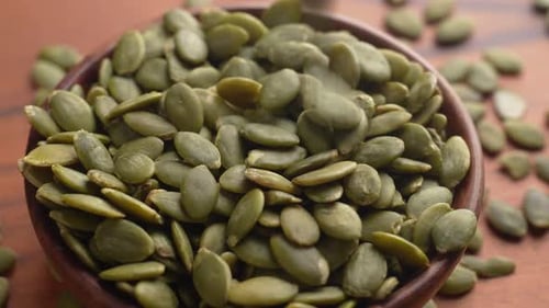 Macro View of Toasted Green Pumpkin Seeds in a Bowl