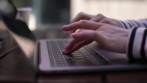 Close Up of Hands Typing on Laptop Keyboard