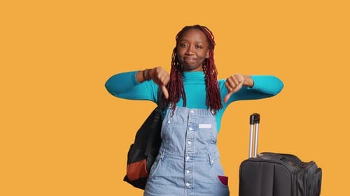 Young Woman Giving Thumbs Down Gesture on Orange