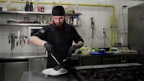 Chef Plating Food in a Commercial Kitchen