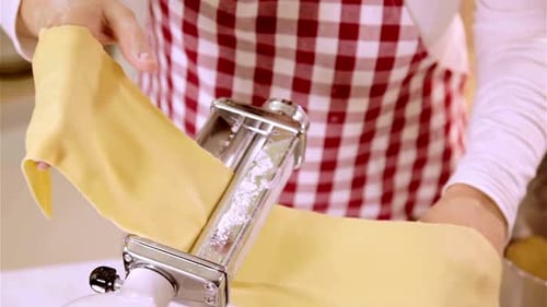 Woman Making Pasta Dough with Pasta Machine