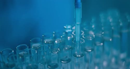Liquid Being Added to Test Tubes in Lab