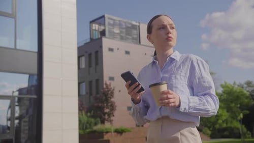 Young Adult Businesswoman Walking From Office
