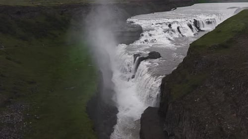 Dynamic Motion of Gullfoss Waterfall Cascading Into Rugged Canyon