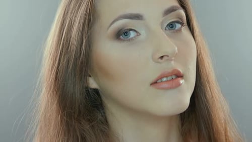 Video Portrait of a Young Woman Isolated on Gray