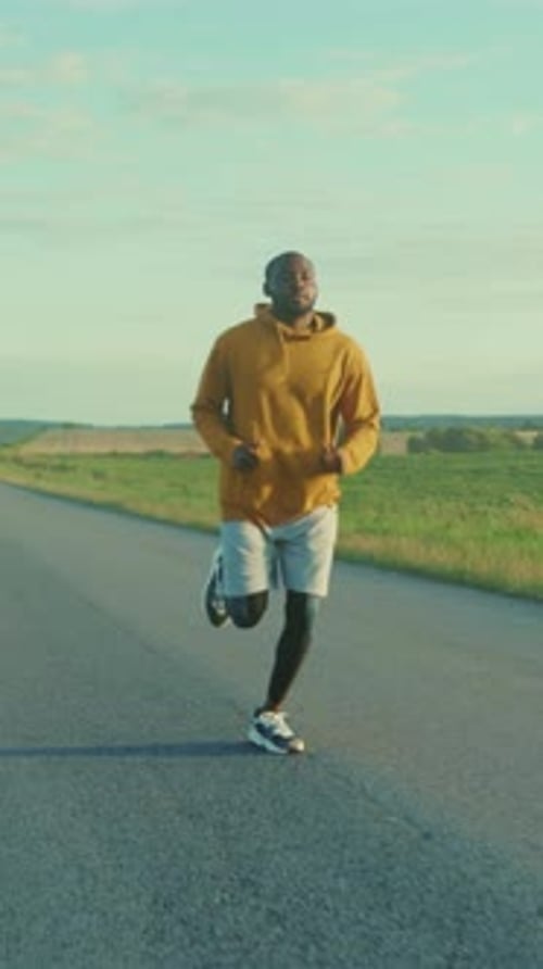 Leisurely Run in Rural Area During Sunset Relaxed Runner Passing Through Open Countryside Under Warm
