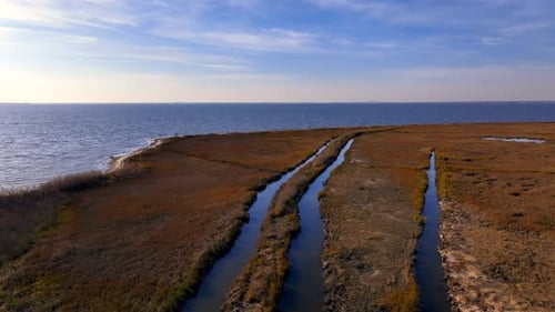 A low altitude, aerial view over a salt marsh on the south shore of Long Island, New York on a sunny