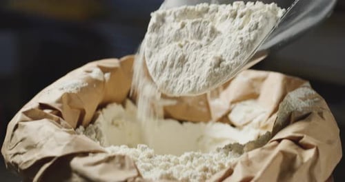 Flour in Bag Poured With Scoop