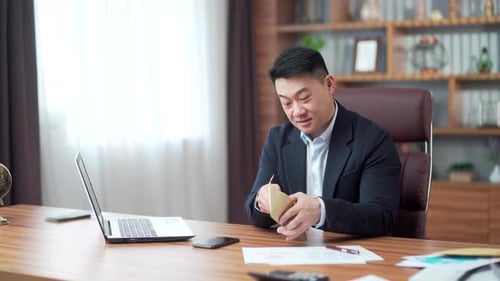 Business employee man in office counts the cash money in an envelope, clerk corrupt received a bribe