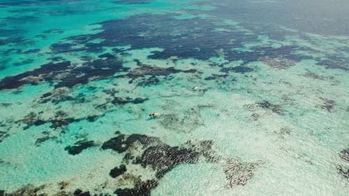 Turquoise Ocean Aerial with Kayak and Paddle Board