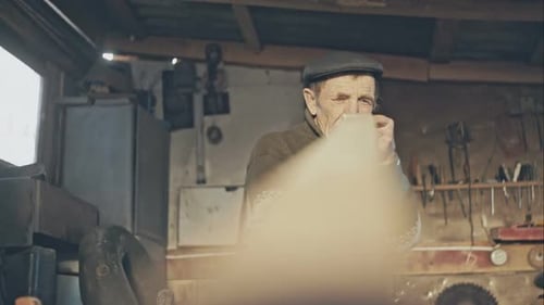 Senior Man Working in Workshop With Wood