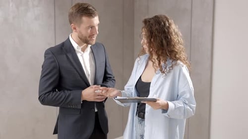 Woman and Man Discussing Business Indoors