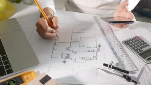 Architect Using Smartphone to Review Building Plan