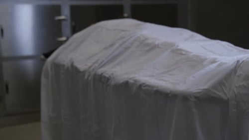 Deceased Person Covered with Sheet on Gurney