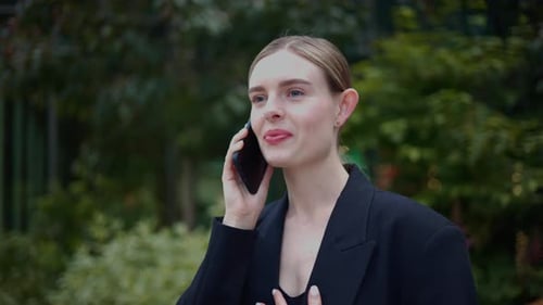 Busy Happy Successful Businesswoman Talking on Cell Phone in the City Center