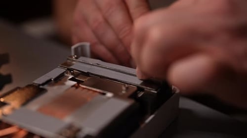 Closeup Hands of Professional Technician Carefully Applying Thermal Paste to Computer Processor