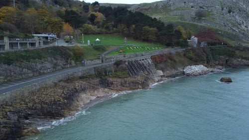Llandudno botanical gardens place name written in chalk aerial view above coastal landmark slow push