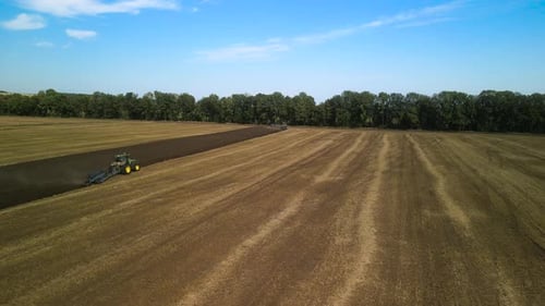 Tractors plowing the field in Ukraine