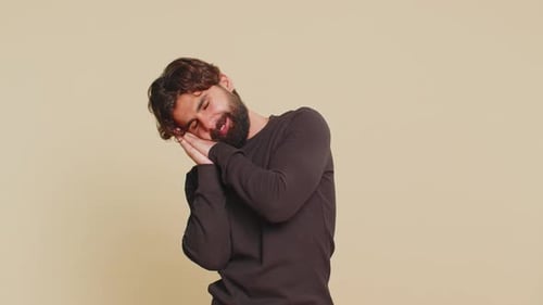 Bearded Man Yawning and Pretending to Sleep