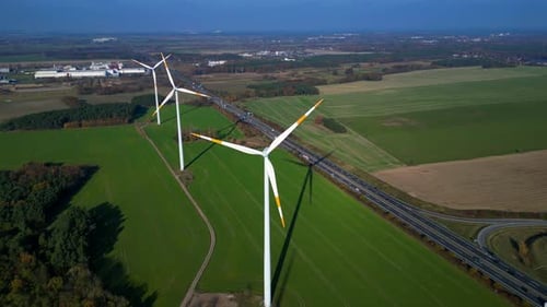 Wind farm Windmill turbines near highway clean energy. Lovely aerial view flight drone