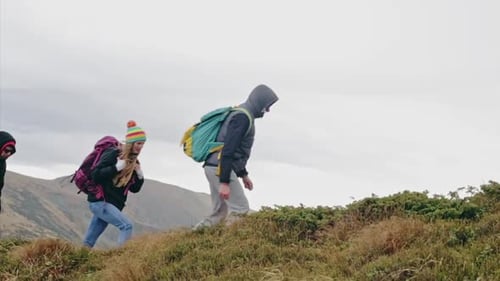 Group Hiking Uphill in Rural Mountainous Area