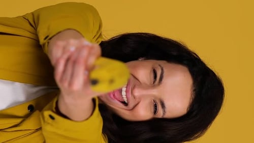 Young Woman Laughing and Posing With Banana