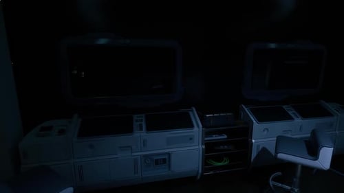 Control Room with Darkened Screens and Minimal Lighting at Night
