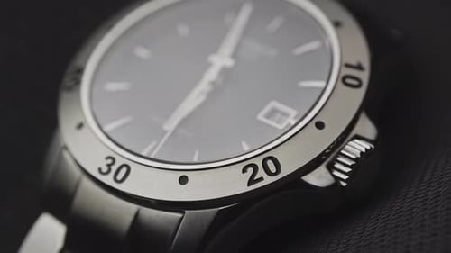 Elegant Silver Watch Close Up on Dark Surface